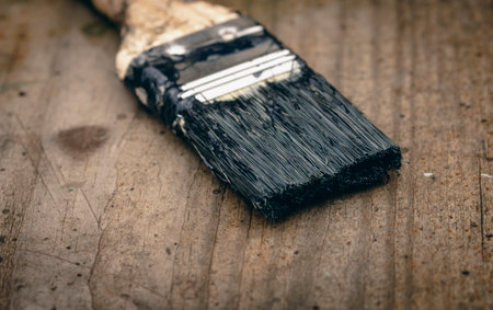 Brush covered with paint on a wooden backgroundの写真素材