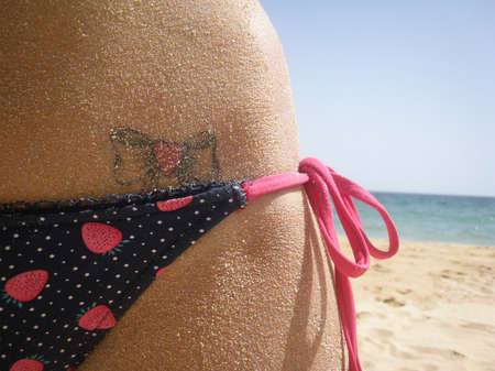  heart loop shaped tattoo on the beachの写真素材