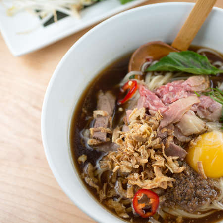 Beef Pho. Smoked Rare Brisket
Crispy Shallot, Scallion, Roasted Garlic Sauce and Rice Noodles and raw eggの写真素材