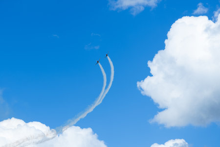 Aerobatics in the blue sky with white clouds. Air show