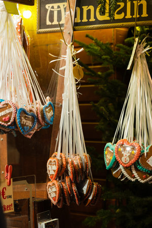 Traditional Christmas gingerbread cookies in the shape of a heart hanging on the wall of a cafeの写真素材