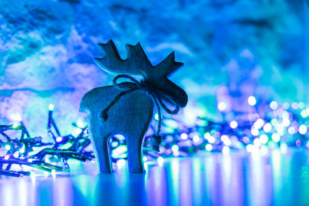 Christmas decoration with wooden reindeer and bokeh lights.の写真素材