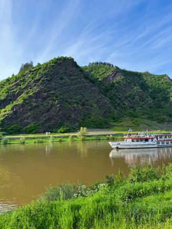 River cruise on the background of the mountains and blue sky with clouds