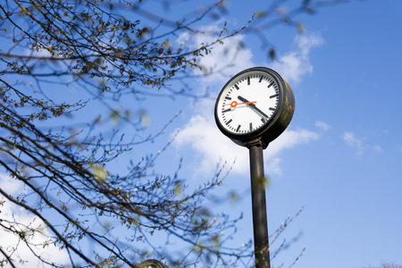Clock on the street with blue sky in the background. Time conceptの写真素材
