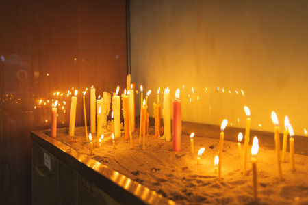 Burning candles in the church, close-up of candlelightの写真素材