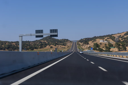 empty highway in Italy with a blue sky and cloudsの写真素材