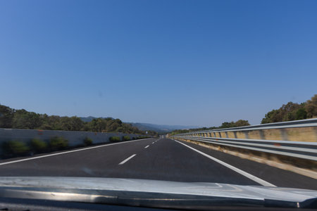 View from the car on the road to the mountains and the blue sky Sardinia Italyの写真素材