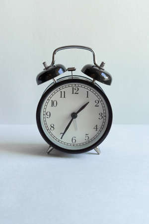 clock with alarm clock on white background with place for inscription. time management, business investment, planningの写真素材