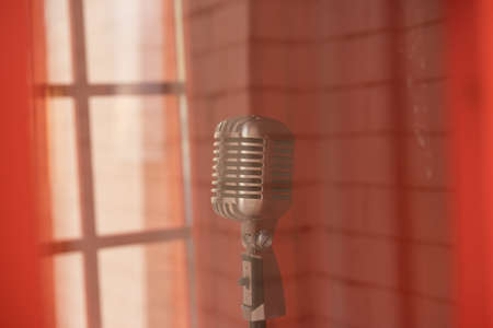 Retro microphone on blurred background, closeup. Space for textの写真素材