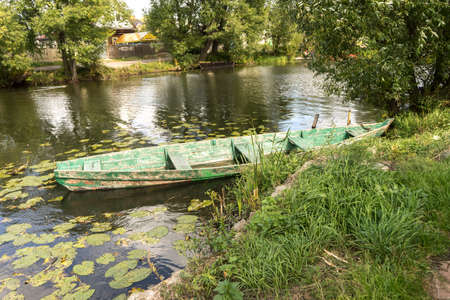 Rowing boat floating over the Lake. Fishing lake in early summer.の写真素材