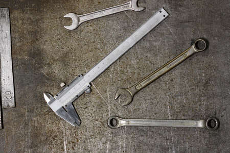 Top view of metal tools, wrenches and spanner on the background of old surfaceの写真素材
