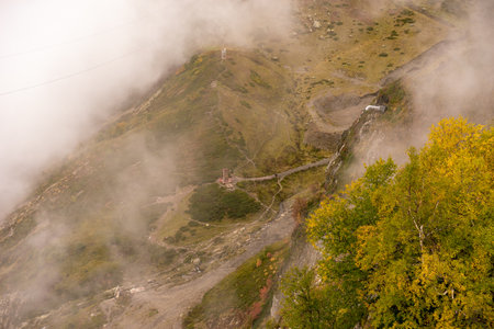 Mountain range with visible silhouettes through the morning colorful fog.の写真素材