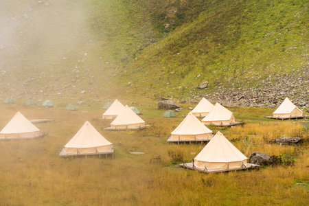 tourist tent camping in mountains at sunset after hikingの写真素材