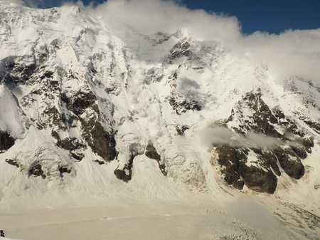 Power of nature. Real huge avalanche comes from a big mountainの写真素材