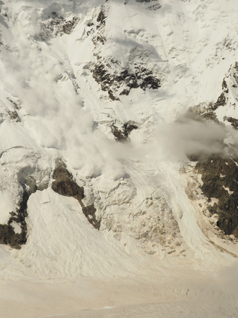 Power of nature. Real huge avalanche comes from a big mountainの写真素材