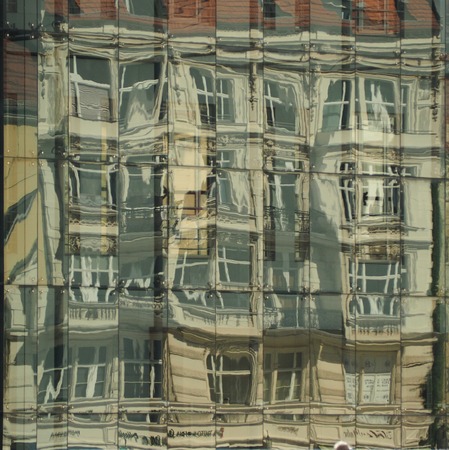 Reflection of the city in the windows of a glass of building. Fine art.の写真素材