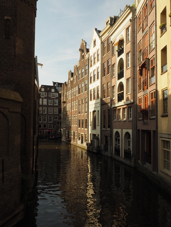 Amsterdam, Netherlands. View of traditional houses in Amsterdam Netherlands Europe. Sunset. Evening. European style houses. Channelsの写真素材