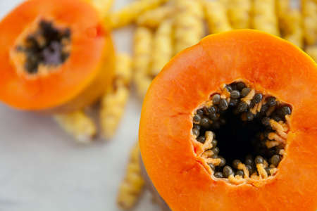Ripe orange papaya cut in half crosswiseの写真素材
