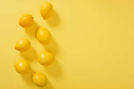 High Angle View Of Lemons Yellow Backgroundの写真素材