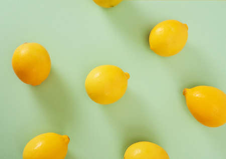 Lemons isolated on green background. High Angle View Of Lemons. Free space for text.の写真素材