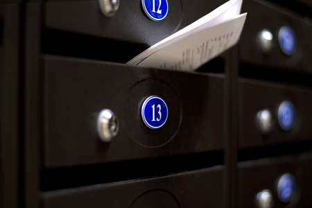 Mailboxes in an apartment house. The letter in the mailbox