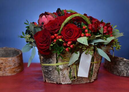 Bouquet of red roses in a box of birch barkの写真素材