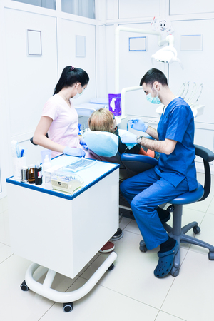 Dentist and nurse treated a female patient's tooth in the clinicの写真素材