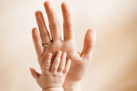 Close-up of baby s hand in mother s handの写真素材