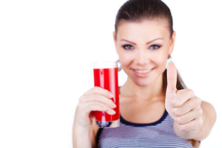 Pretty young woman with glass of juice isolated on the white の写真素材
