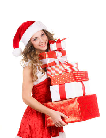 Christmas woman holding presents excited  Young happy woman wearing santa hat looking to side showing Christmas gift isolated on white background  Beautiful young santa woman の写真素材