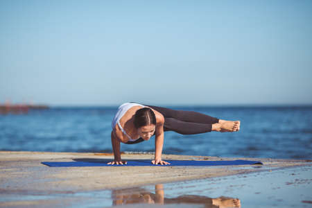 Healthy woman resting and curl up in fetal position outdoor at the sea  yoga pose  Series 