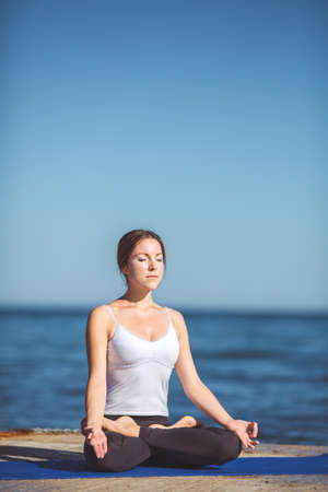 Healthy woman resting and curl up in fetal position outdoor at the sea  yoga pose  Series の写真素材