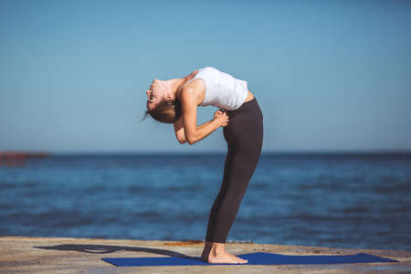 Healthy woman resting and curl up in fetal position outdoor at the sea  yoga pose  Series の写真素材