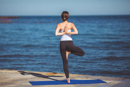 Healthy woman resting and curl up in fetal position outdoor at the sea  yoga pose  Series の写真素材