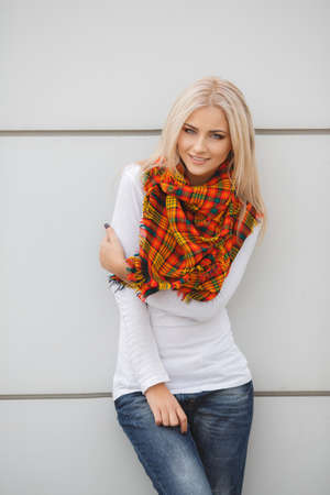 Close up portrait of young blonde beautiful woman in warm autumn scarf  Ourdoors の写真素材