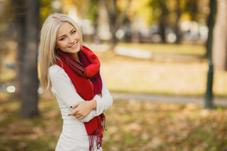 Close up portrait of young blonde beautiful woman in warm autumn scarf  Ourdoors の写真素材