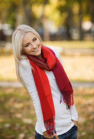 Close up portrait of young blonde beautiful woman in warm autumn scarf  Ourdoors の写真素材