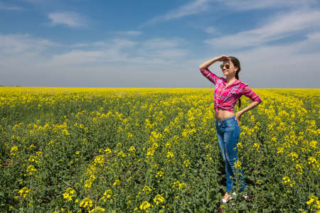 Young beautiful woman in flowering field in summer  Outdoorsの写真素材