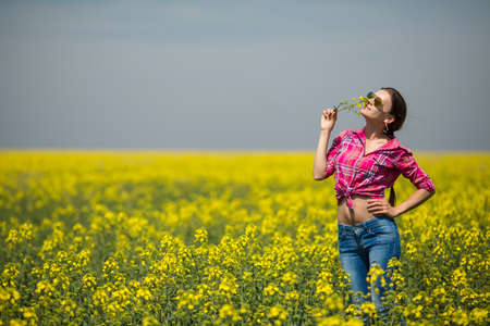 Young beautiful woman in flowering field in summer  Outdoorsの写真素材