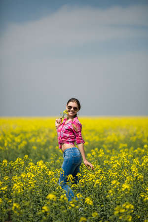 Young beautiful woman in flowering field in summer  Outdoorsの写真素材