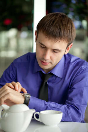 Business man with the laptop drinks coffee in cafeの写真素材