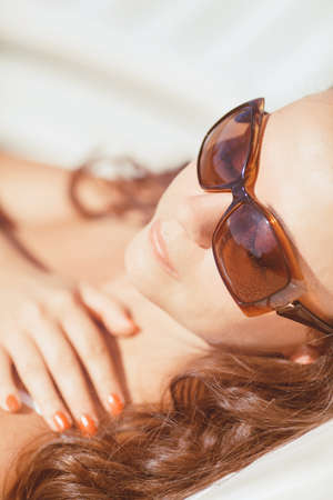 Young woman resting at beach near the seaの写真素材