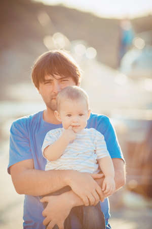 Father playing with his son on the pier near yacht club in summer  Outdoorの写真素材