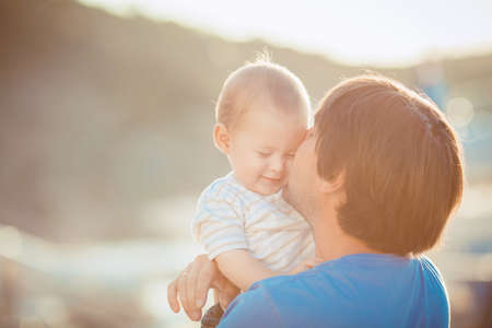 Father playing with his son on the pier near yacht club in summer  Outdoorの写真素材
