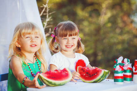 Cute happy children playing in spring filedの写真素材