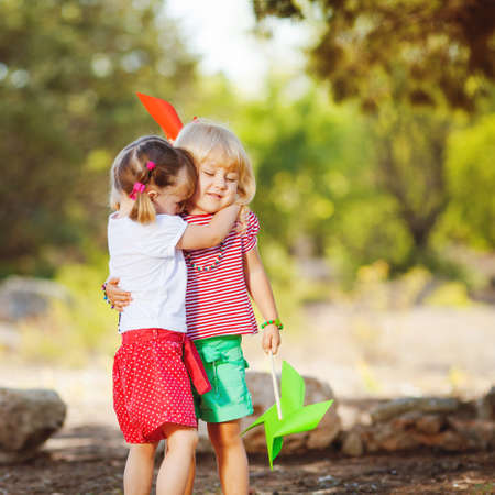 Cute happy children playing in spring filedの写真素材