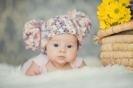 adorable smiling newborn baby girl lies in basket
