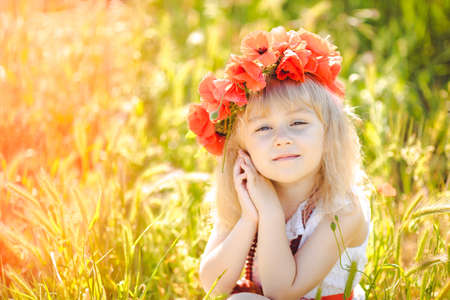 Cute child girl in poppy fieldの写真素材