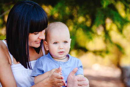 Young mother with child outside on a summer day の写真素材