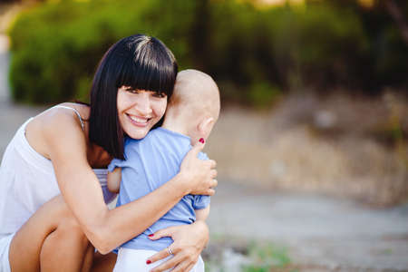 Young mother with child outside on a summer day 